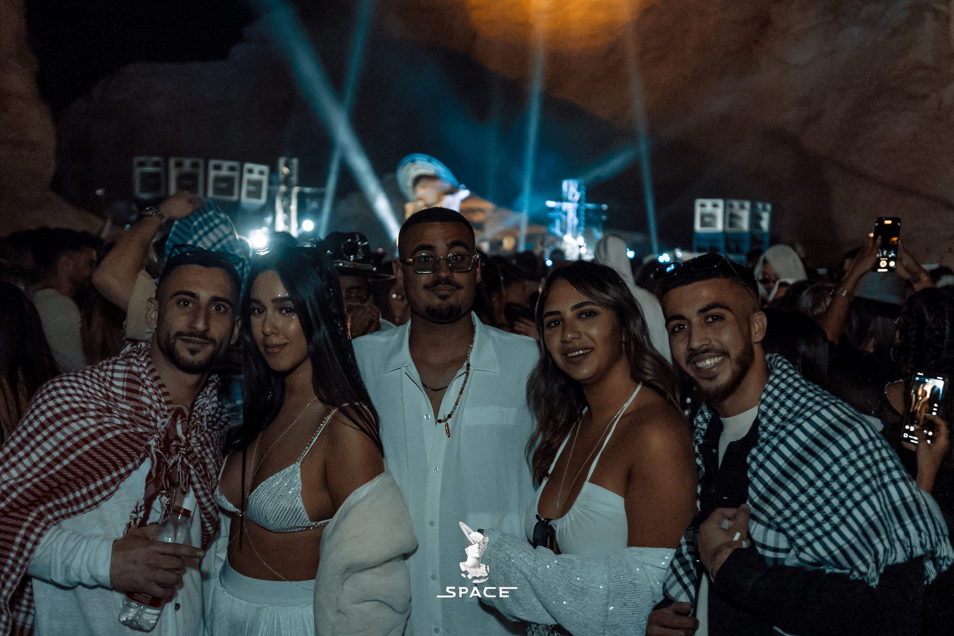 A group of friends dressed in white at a SPACE night gathering