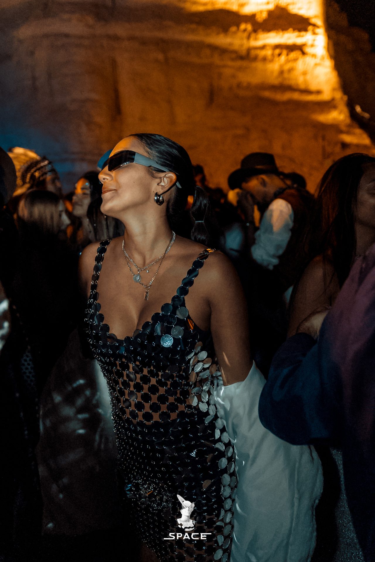 A dancer in blue light inside a desert canyon at a SPACE night event