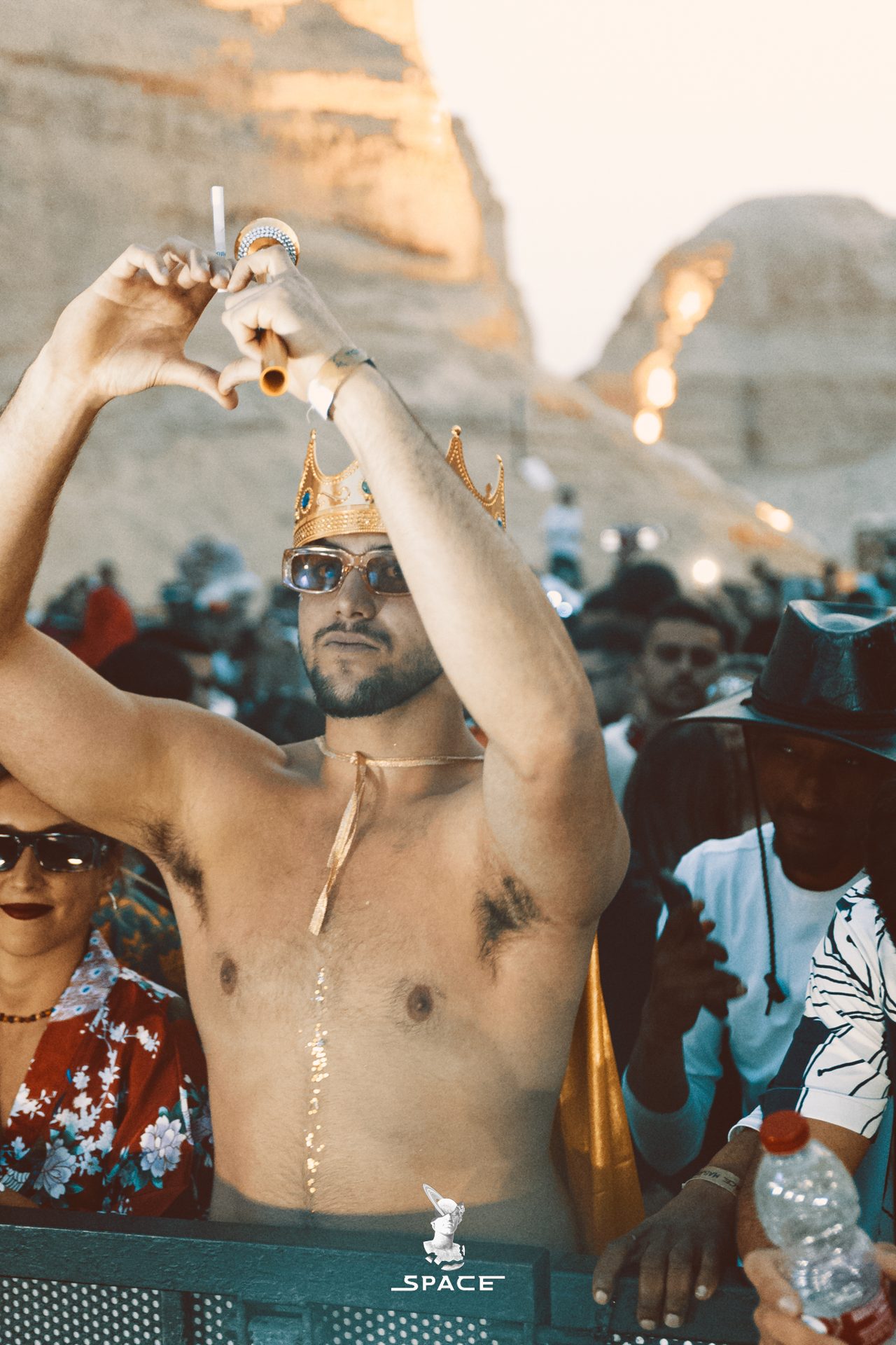 A dancer with arms raised against first light over the desert